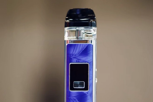 Close-up view of a disposable vape device with a purple design and a black display screen