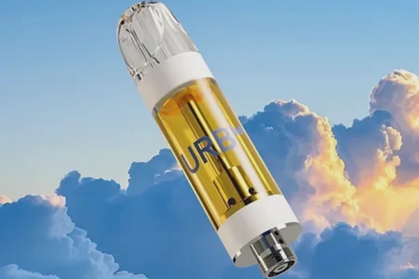 Clear Urb vape cartridge floating against a backdrop of blue sky and clouds