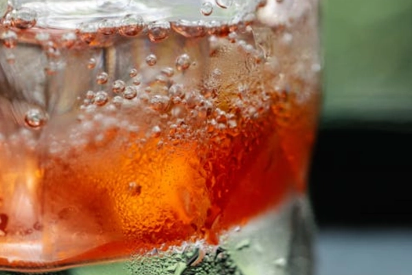 Refreshing red hemp seltzer with ice and bubbles